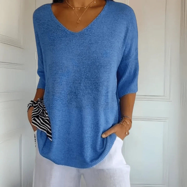 Close-up of the V-neckline and 3/4 sleeves on a women's relaxed fit top, highlighting quality and style.