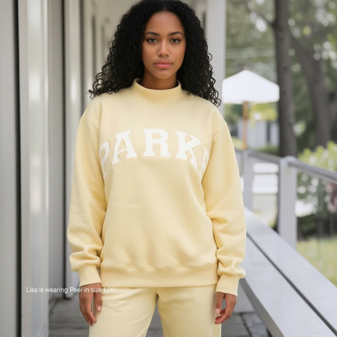 Relaxed fit women's sweater, varsity style for casual fashion & everyday comfort.
