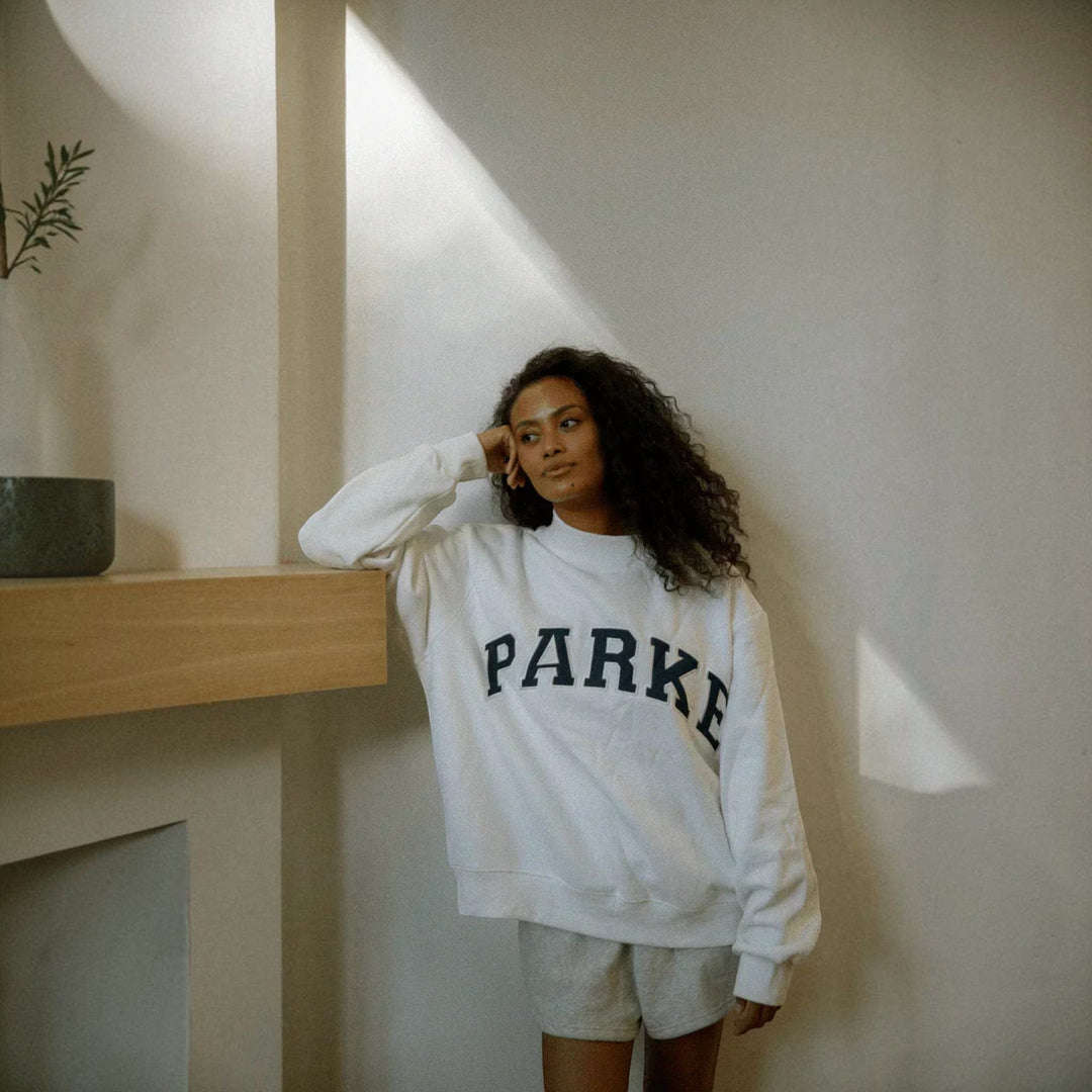 Relaxed fit women's varsity style hoodie, perfect for collegiate casual fashion.