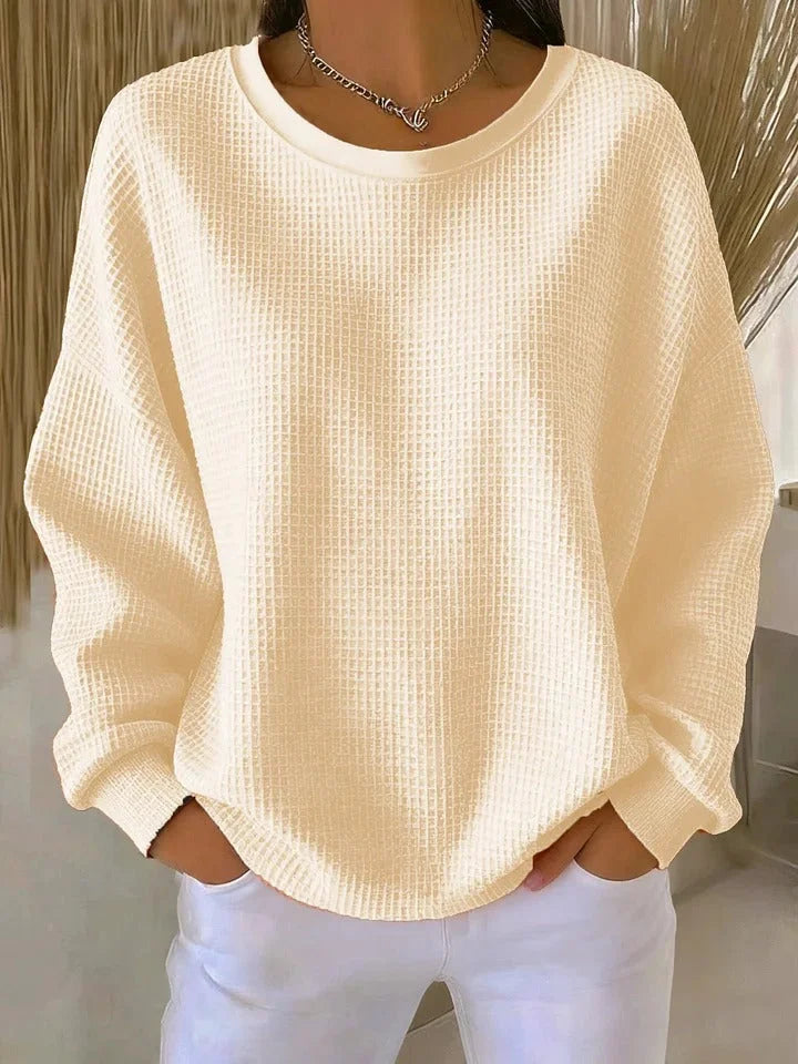 Cozy women's relaxed fit sweater, featuring a stylish waffle knit and comfortable long sleeves.