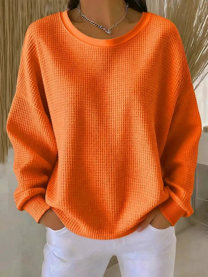 Layering-friendly women's waffle knit sweater. Relaxed fit, long sleeves, perfect for casual comfort.