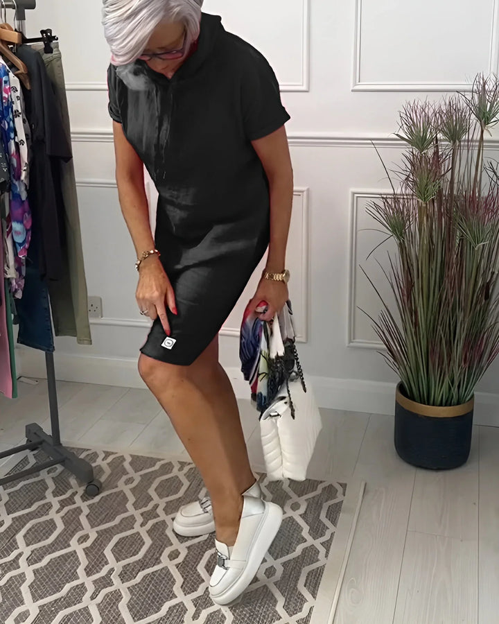 Women's summer mini dress, relaxed hoodie style, with short sleeves and side pockets for casual comfort.