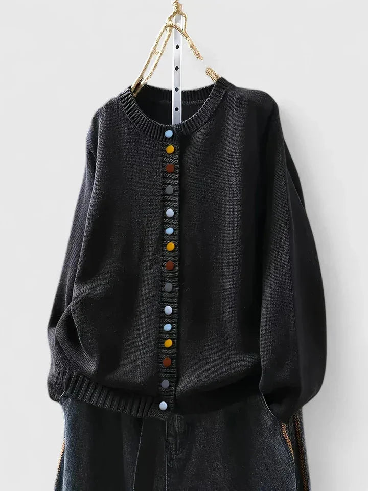 Button-front women's knit cardigan sweater featuring a relaxed fit and vibrant multi-color buttons. Casual.