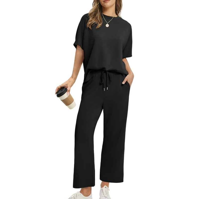 Elegant women's ribbed top & trousers set. Comfortable two-piece outfit for casual wear or sophisticated lounging.