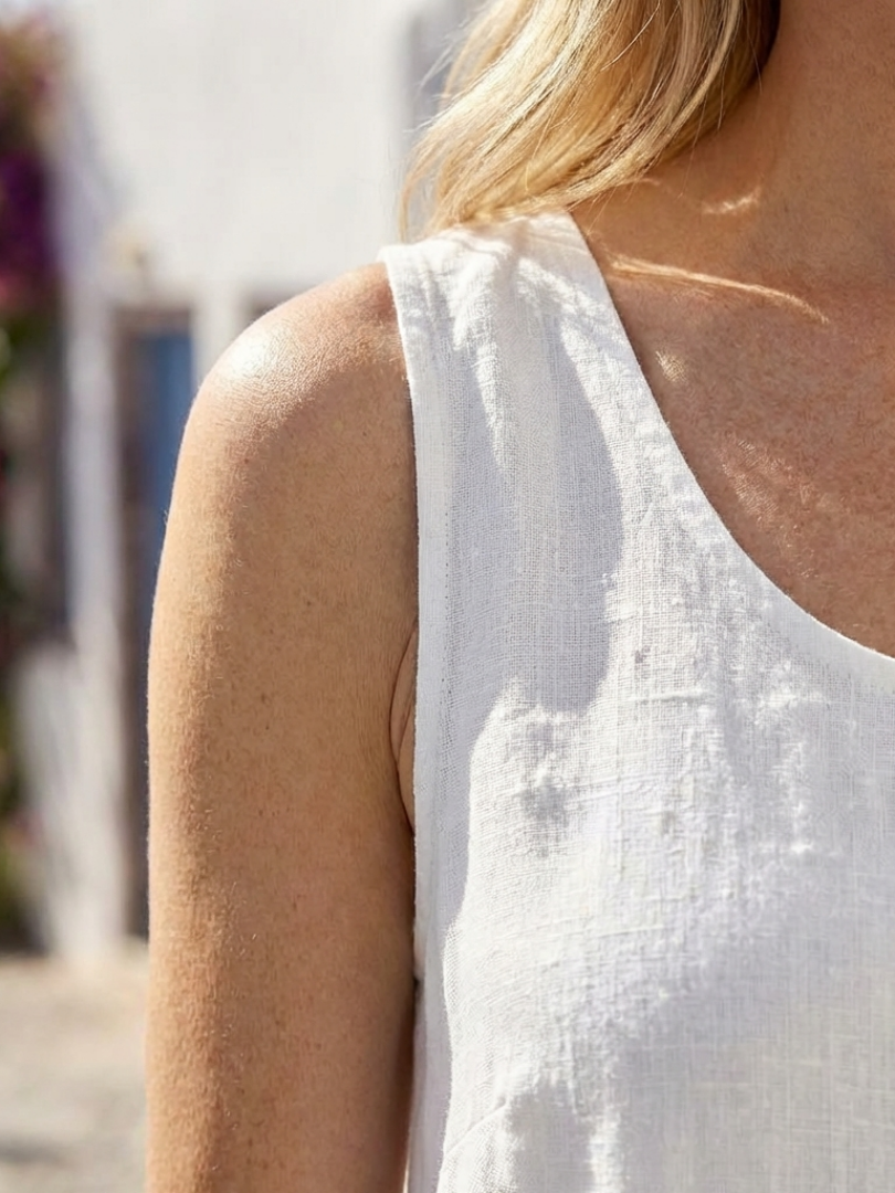 White relaxed fit sleeveless midi dress for women, ideal as a casual and comfortable summer dress.