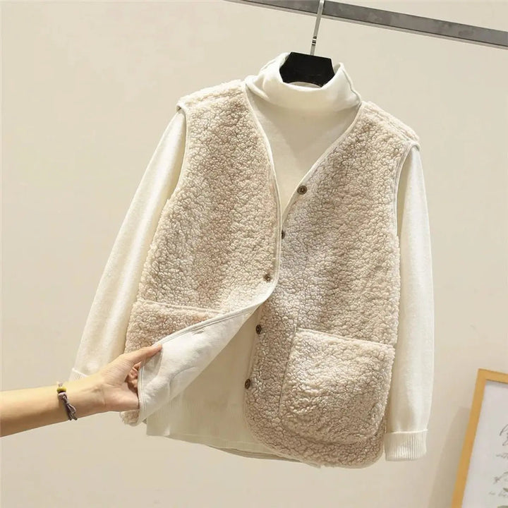 Stylish women's reversible puffer vest, a button-front layering piece. Perfect for autumn & winter outfits.