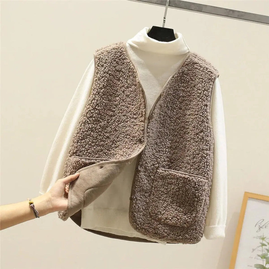Cozy women's sherpa fleece gilet. Reversible puffer vest with button front, ideal for casual autumn warmth.