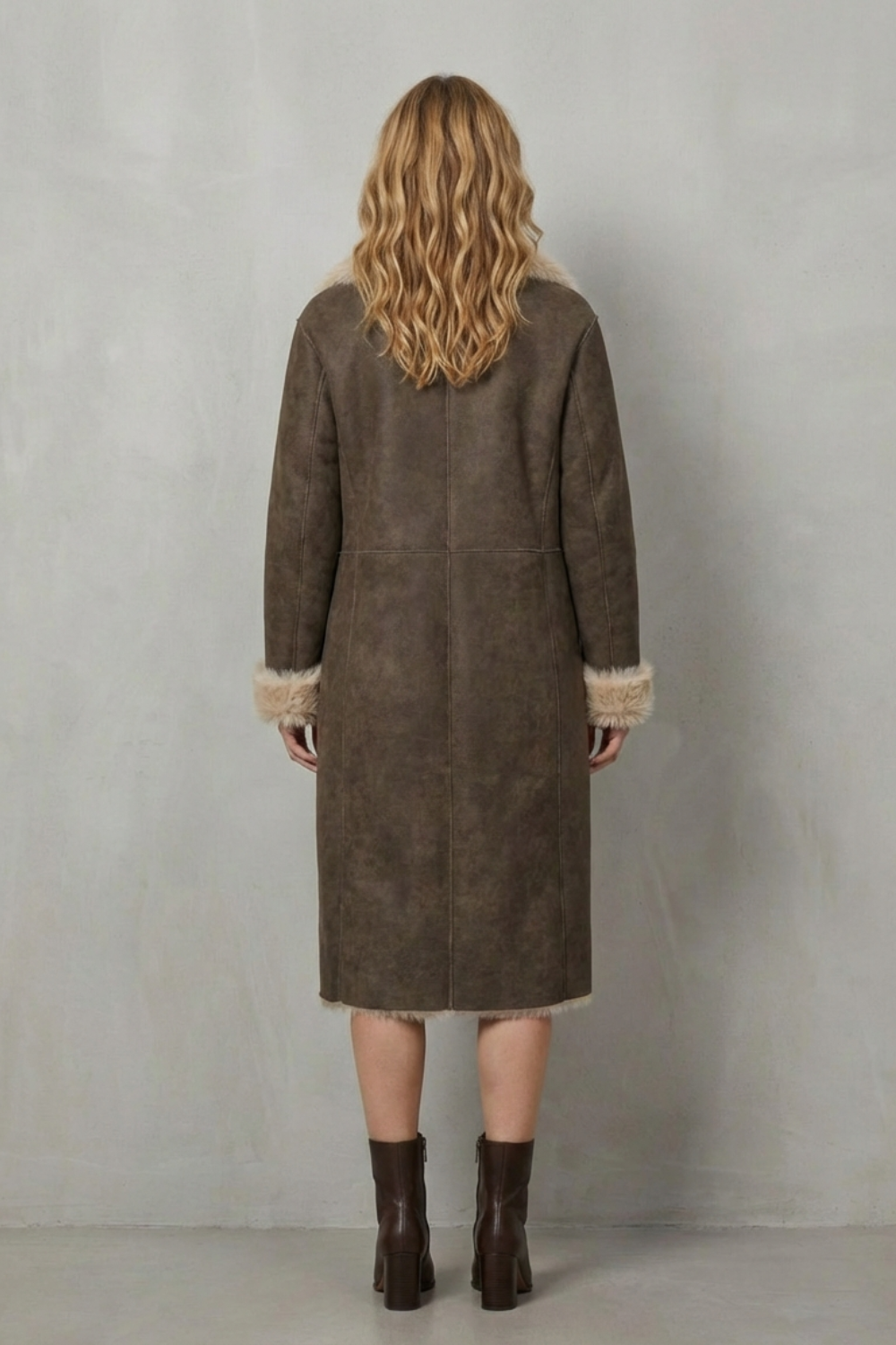 Woman wearing a warm, reversible textured winter coat, demonstrating its stylish and versatile design.