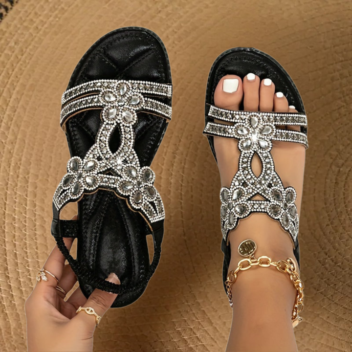 Stylish women's flat summer sandals with intricate rhinestone and crystal embellishments.