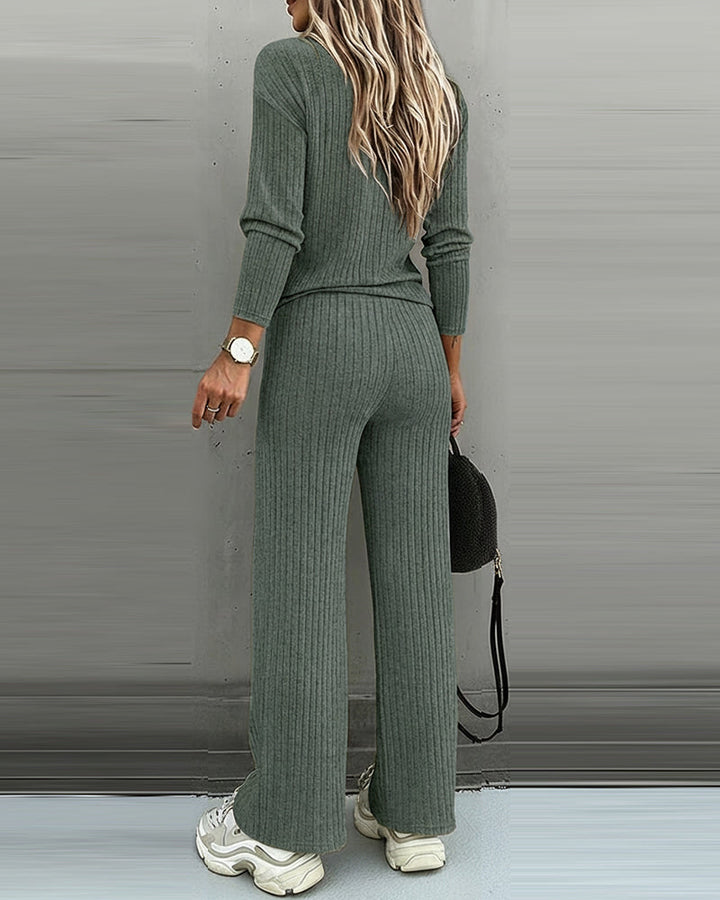 Pullover v-neck knit top paired with women's straight leg pants