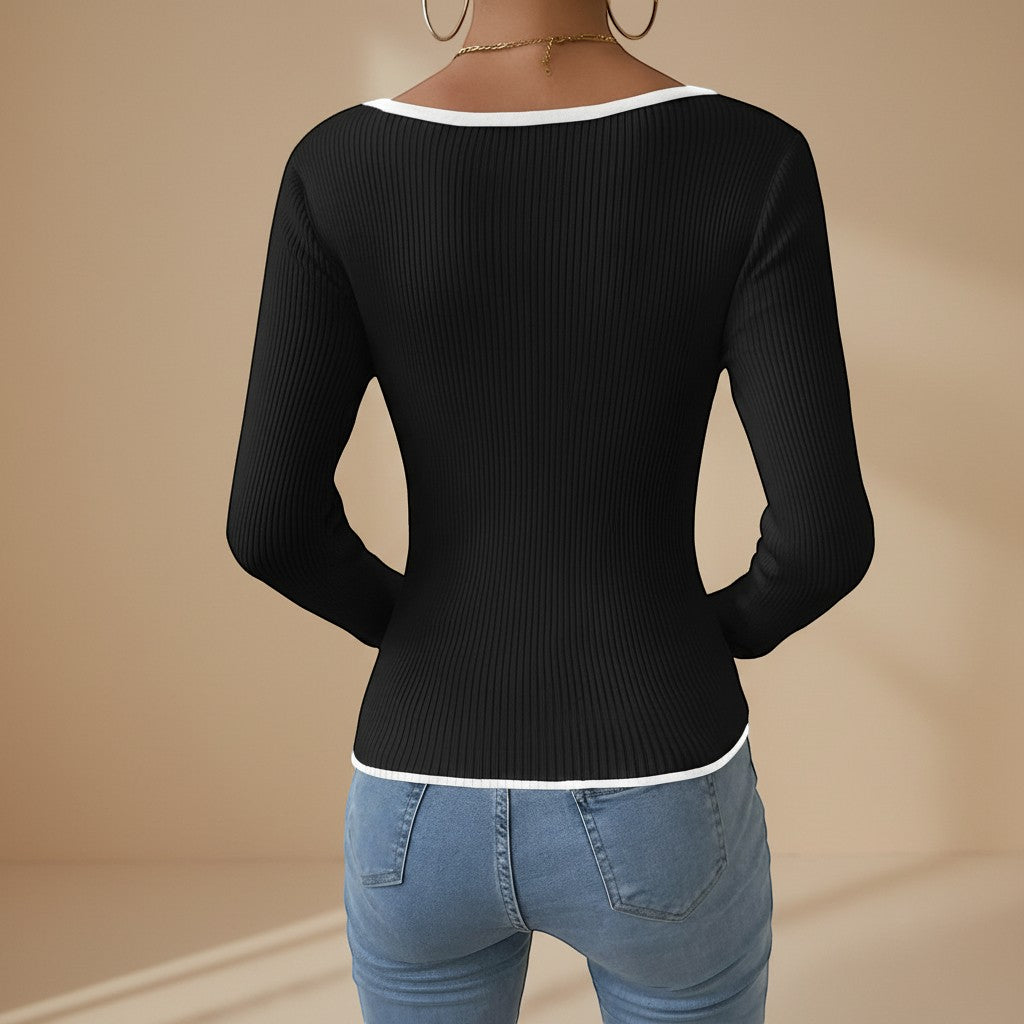 Fitted women's long sleeve ribbed top, featuring a stylish V-neck and contrasting details.