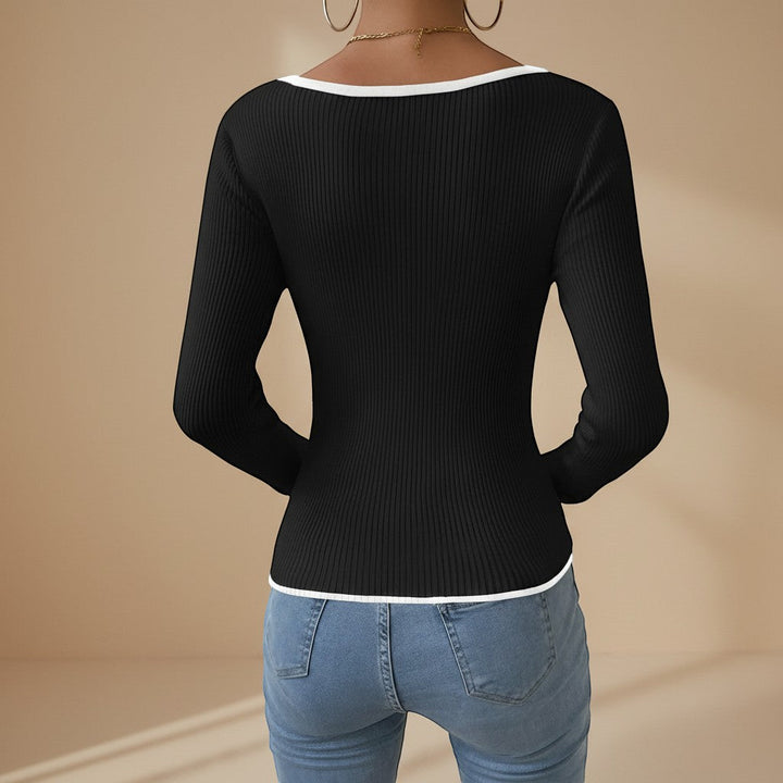 Fitted women's long sleeve ribbed top, featuring a stylish V-neck and contrasting details.