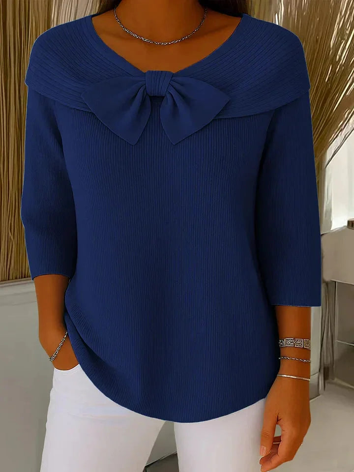 Ribbed knit women's V-neck top with stylish 3/4 sleeves and a charming bow detail. Versatile and chic.