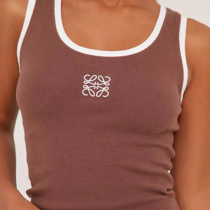 Elegant casual: women's sleeveless top with fashionable rips and stunning embroidery detail.