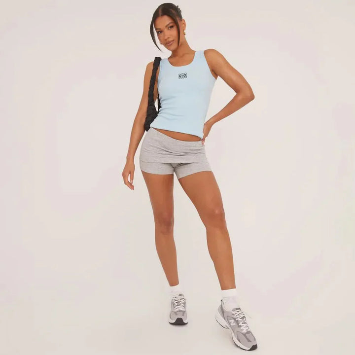 Ripped and embroidered sleeveless top for women, offering a chic and casual elegant style.