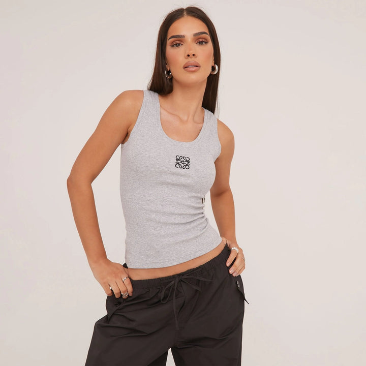 Summer essential: women's ripped tank top with delicate embroidery, for a fresh, stylish look.