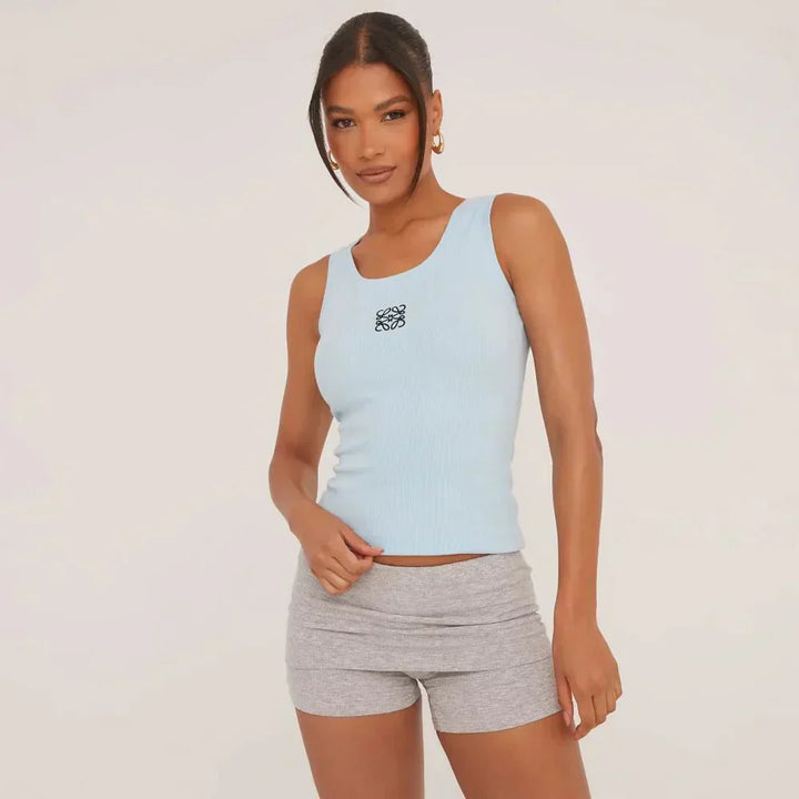 Stylish women's sleeveless top, featuring a ripped texture and beautiful delicate embroidery.