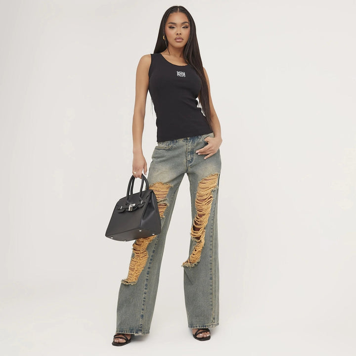 Ripped and embroidered women's tank top, perfect for a casual yet sophisticated summer style.
