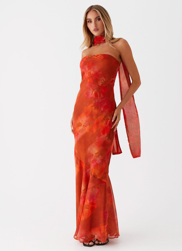 Women's flowing romantic floral print maxi dress. Elegant sleeveless design, perfect for a breezy summer day.