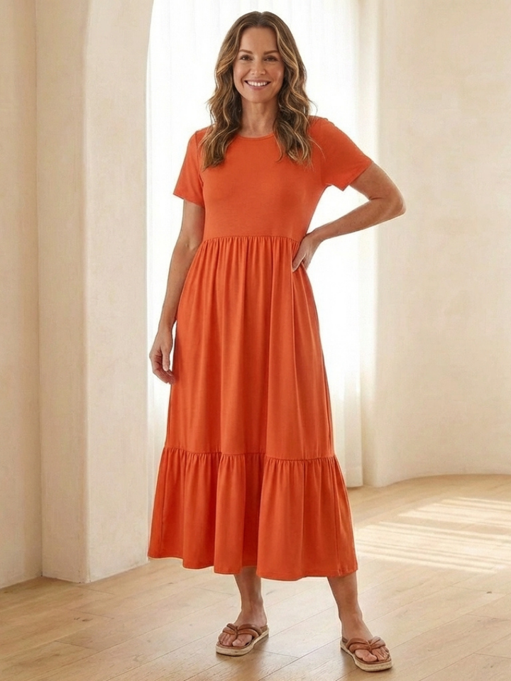 Comfortable short sleeve midi dress for women. Relaxed fit, round neck, and tiered design, ideal for summer casual wear.