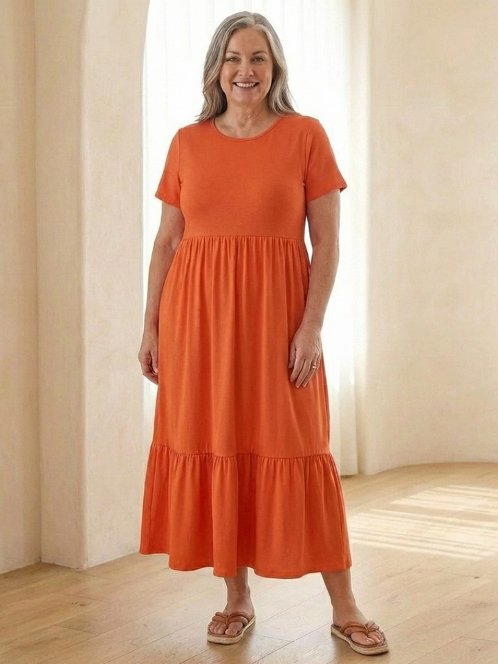Stylish women's tiered midi dress with short sleeves and a round neck. A comfortable, casual choice for any day.
