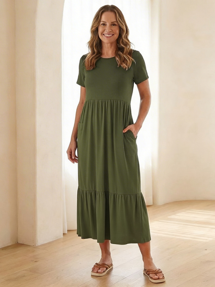 Relaxed fit women's tiered midi dress. Features short sleeves, round neck, and a breezy design for summer comfort.