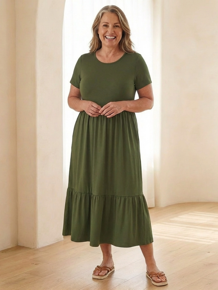 Casual women's short sleeve tiered midi dress with a round neck. Comfortable, versatile, and includes convenient pockets.