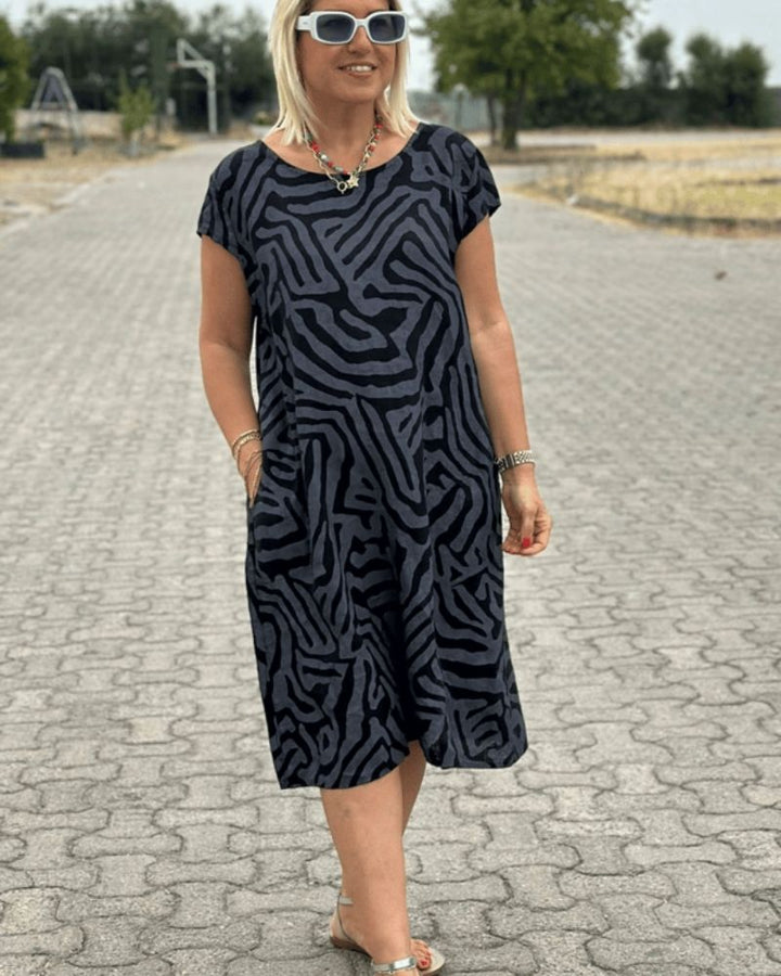 Relaxed fit women's round neck summer dress. Soft, comfortable midi length for casual elegance and sundress style.
