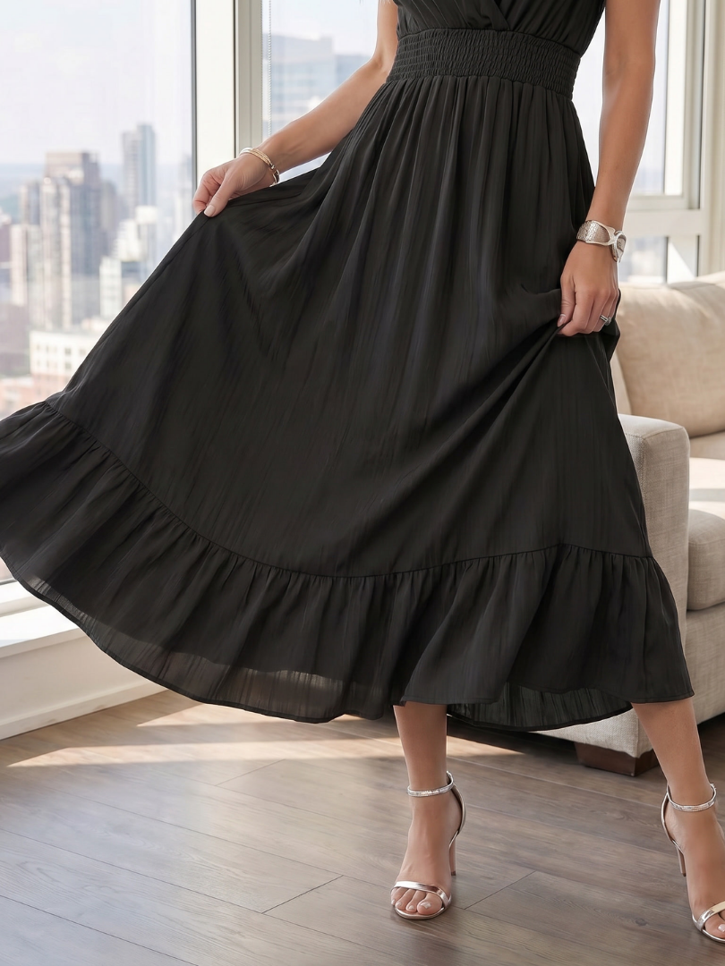 Back view of a women's casual smocked waist midi dress with short ruffle sleeves and a comfortable tiered design.