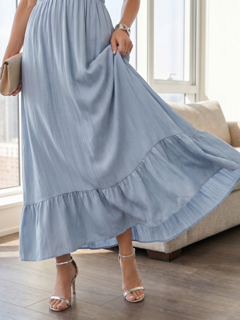 Stylish women's day dress featuring a comfortable smocked waist, short ruffle sleeves, and a flowy tiered midi skirt.