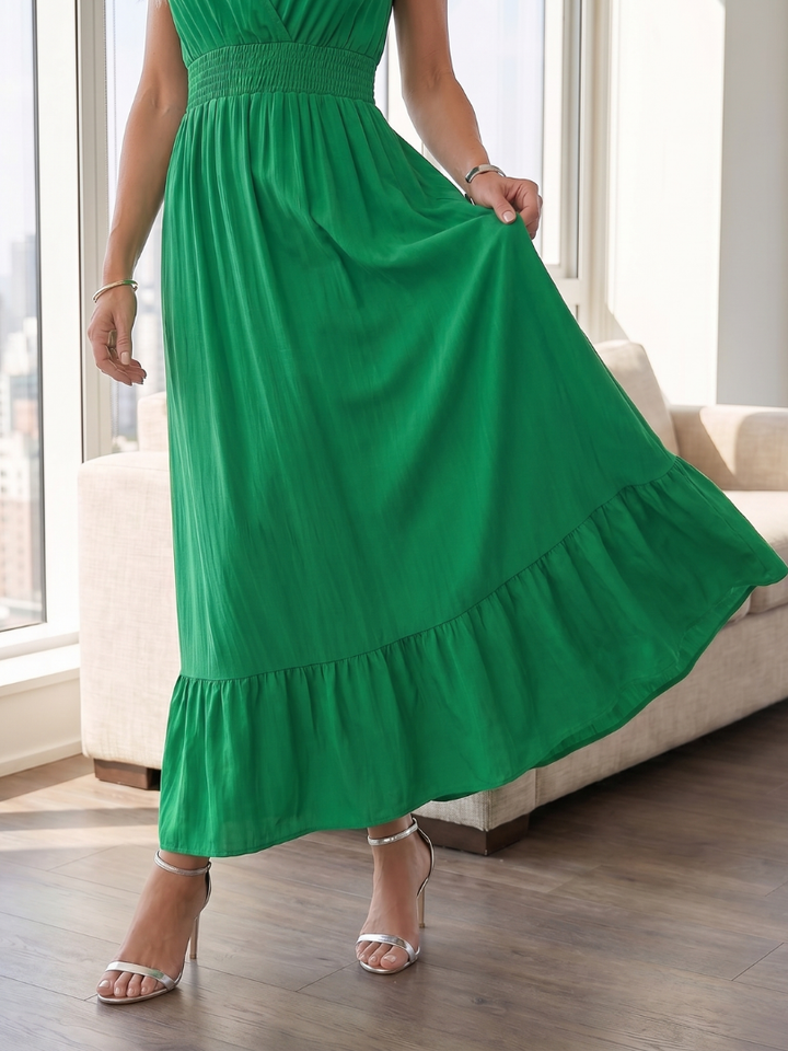 Flowy tiered skirt of a women's smocked waist midi dress, offering a casual yet elegant look for any occasion.
