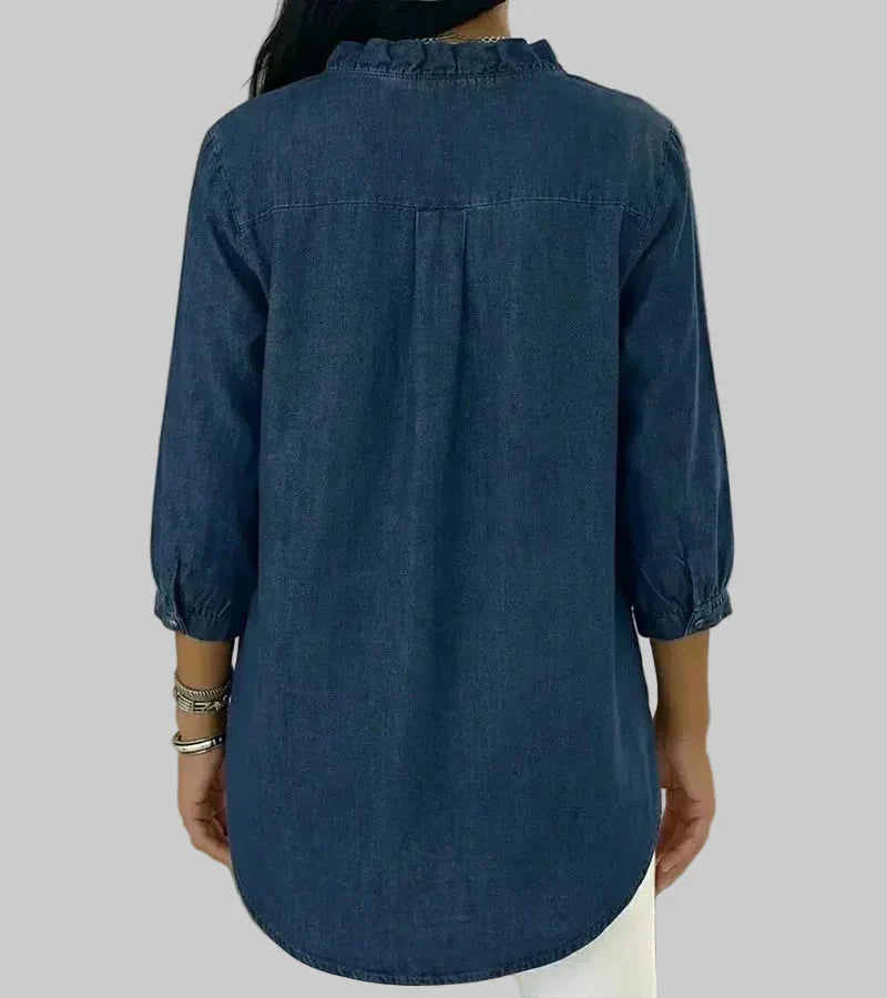 Relaxed fit women's ruffle blouse. Ideal for summer style, featuring a v-neck, 3/4 sleeves, & hi-low hem.