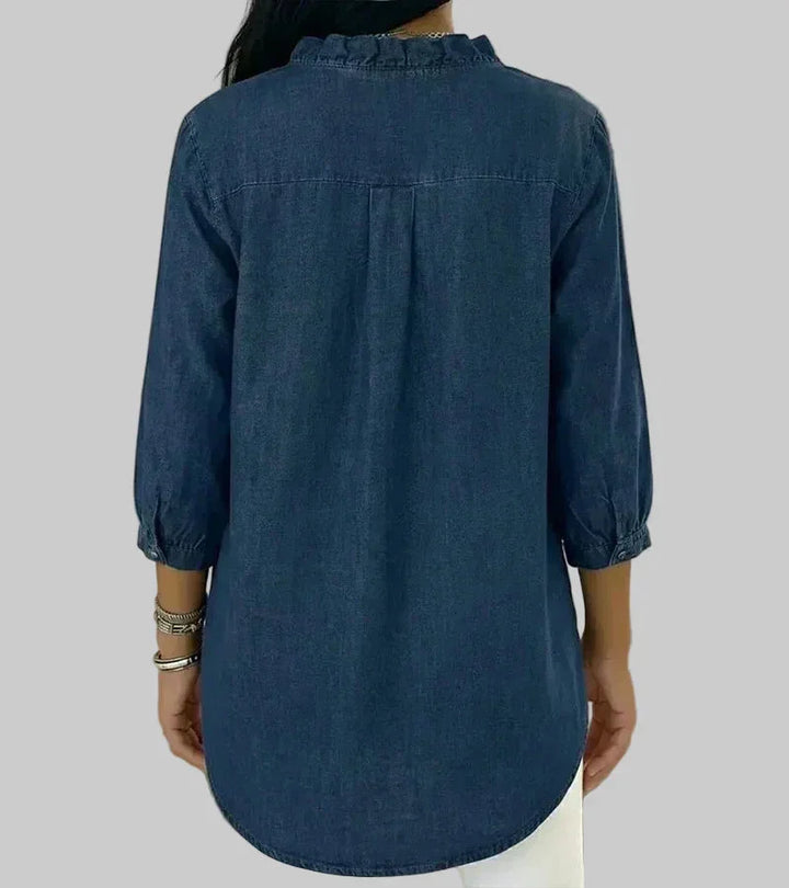 Relaxed fit women's ruffle blouse. Ideal for summer style, featuring a v-neck, 3/4 sleeves, & hi-low hem.