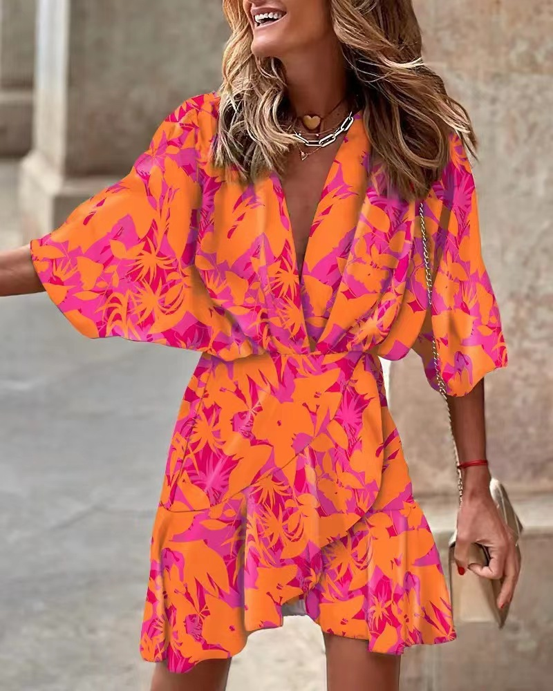 Women's ruffled boho mini dress in a vibrant print, perfect for summer. Effortlessly chic casual bohemian style.