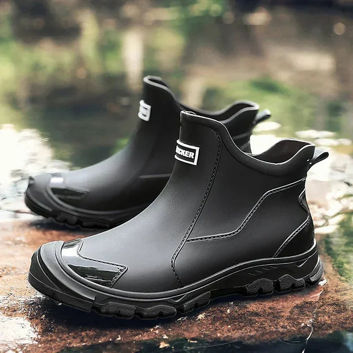 Women's rugged waterproof ankle rain boots with slip-resistant lug sole for wet weather.