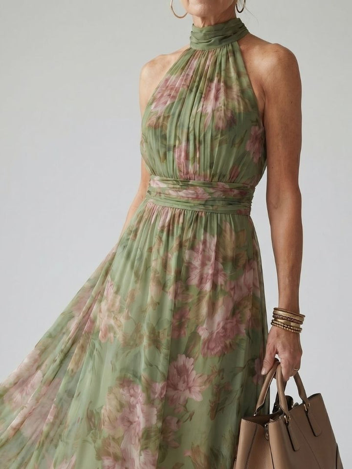 Flowing midi dress for women featuring a delicate floral pattern and stylish halter neckline.