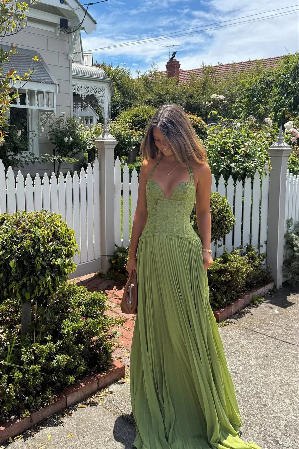 Women's sage green pleated maxi evening dress with a stylish corset bodice, ideal for formal occasions.
