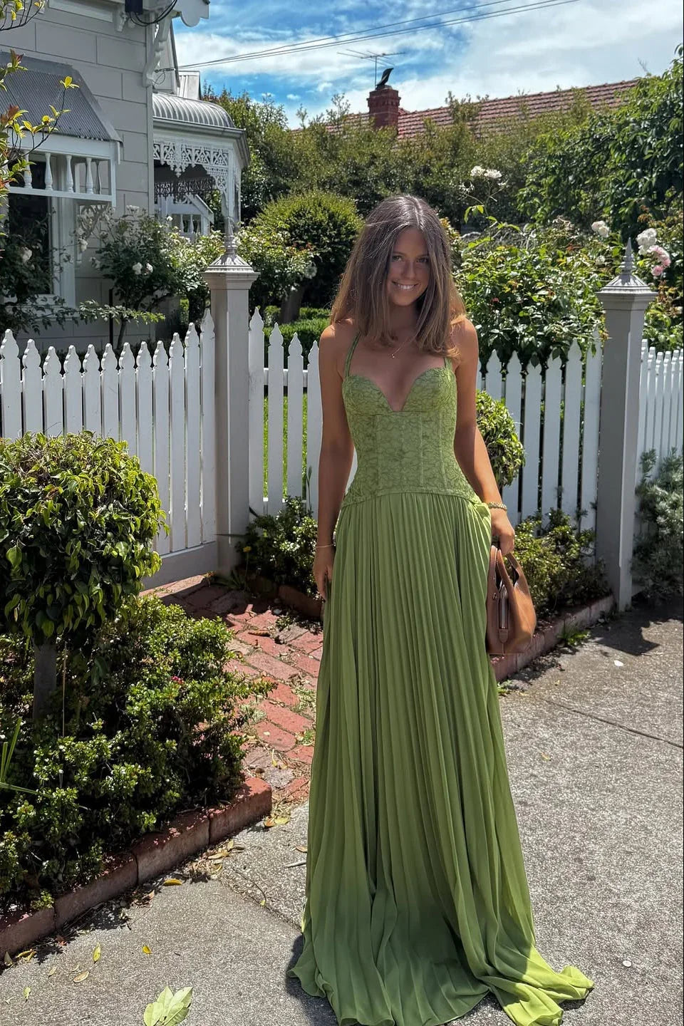 Beautiful sage green formal maxi dress, pleated with a corset, for elegant occasions and party wear.