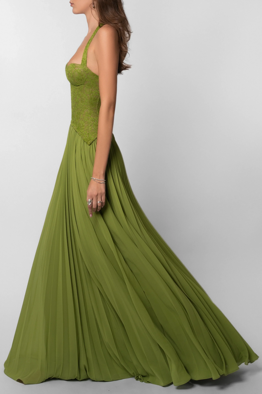 Stunning sage green summer maxi dress, pleated and corseted, ideal for formal occasions and elegant parties.