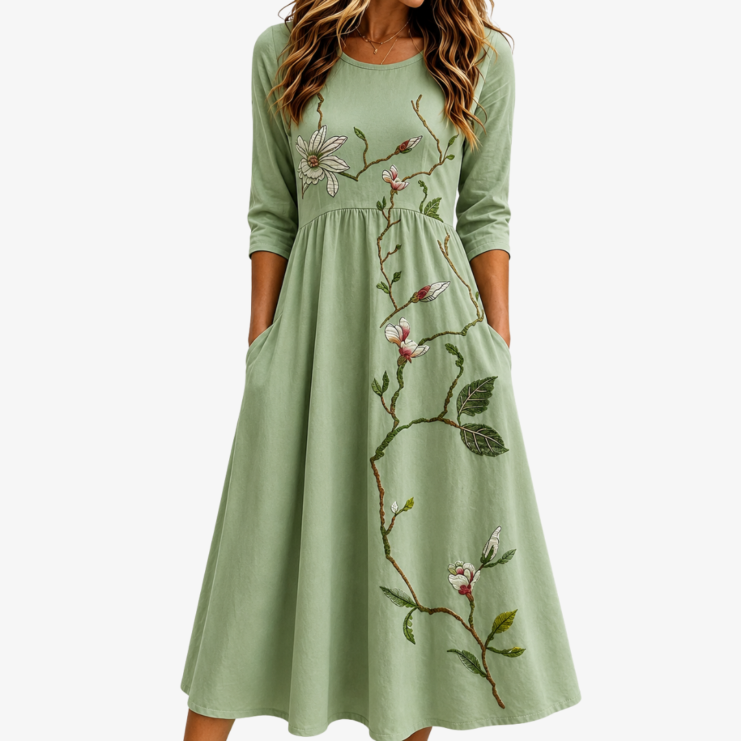 Women's sage green Willow Bloom midi dress with floral print, flowy design, and pockets. Elegant, casual summer style.