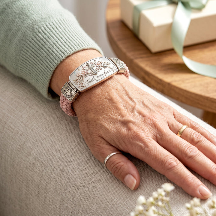 Close-up of the women's cross bracelet, showing detailed Isaiah 41:10 scripture and floral accents.