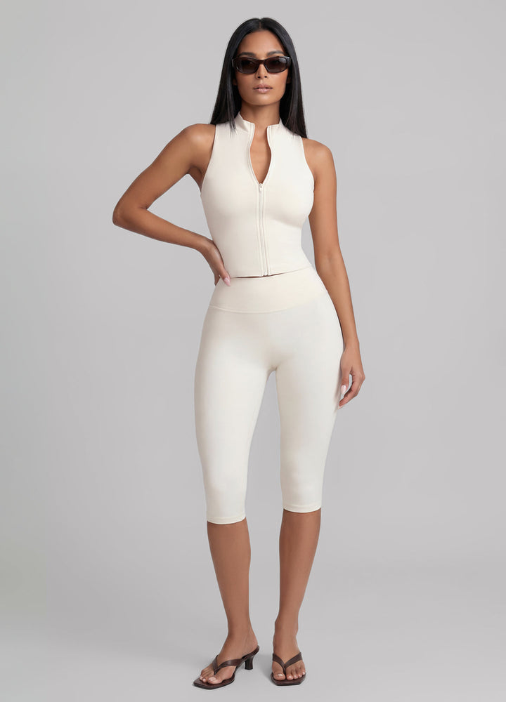 Women's sculpting ivory capri leggings, perfect for Pilates, yoga, and studio workouts. High-waisted fitness wear.