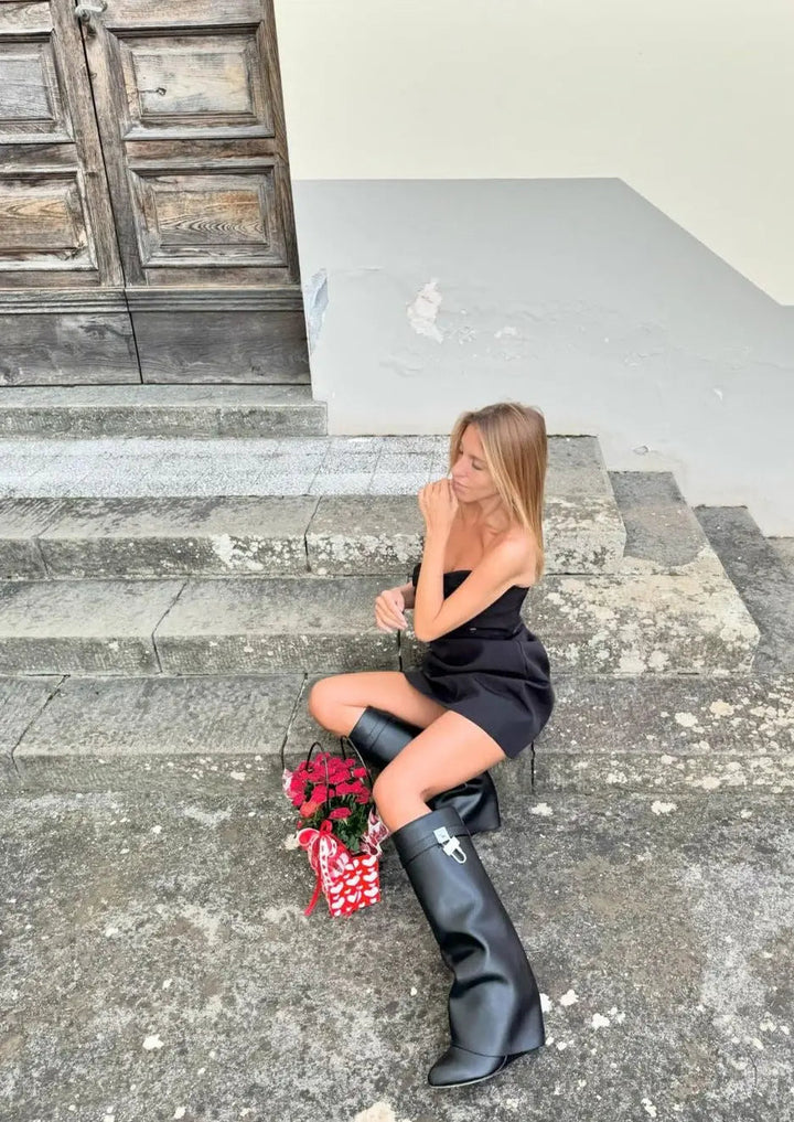 Women's modern knee-high boots: glossy black finish and unique sculptural wedge.