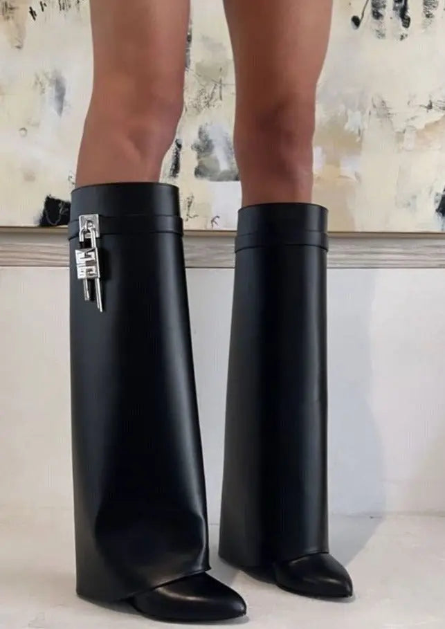 Women's elegant knee-high boots with a glossy finish and modern sculptural wedge.