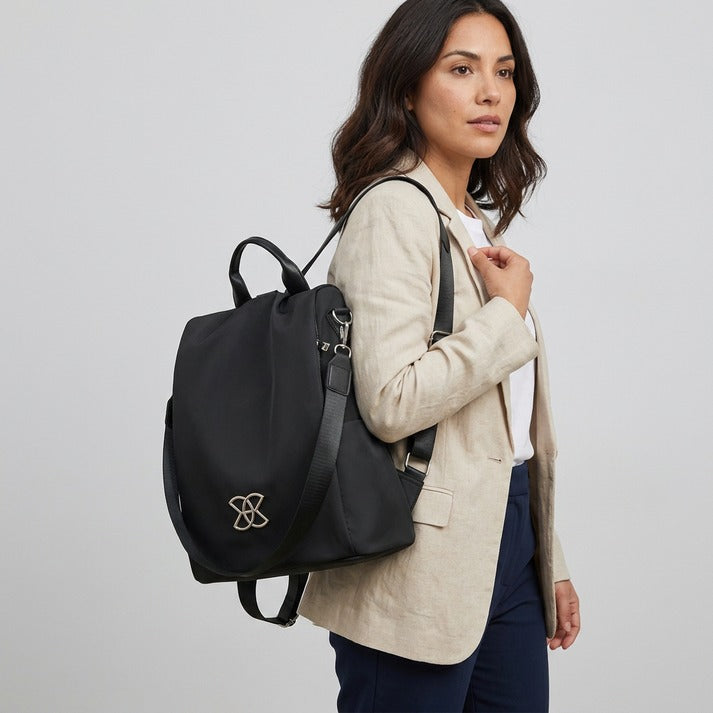 Women's versatile anti-theft travel bag, worn cross-body, demonstrating comfortable & secure carrying style.