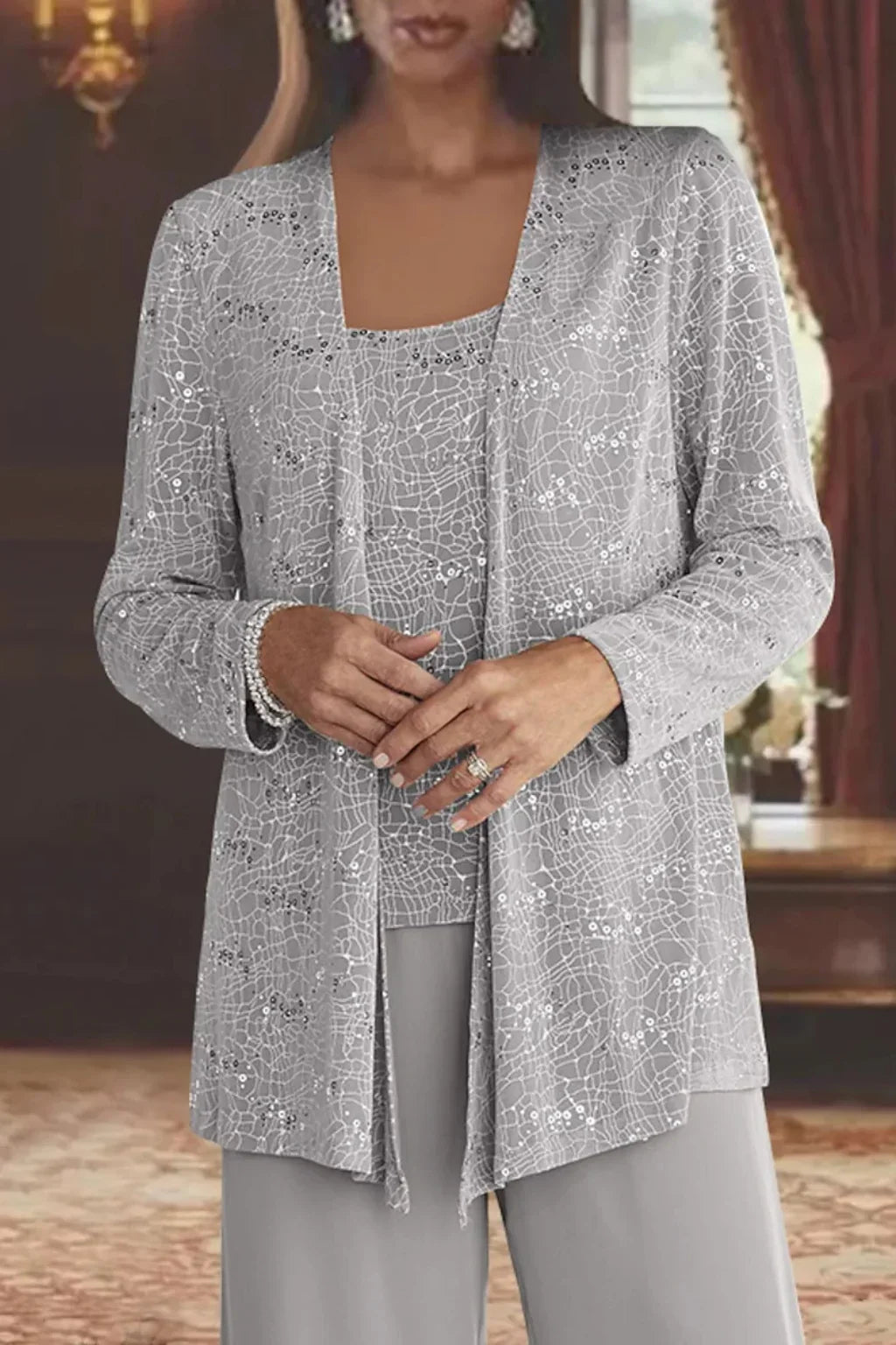 Glamorous women's sequin wide leg pants, part of a stunning three-piece set with matching jacket & top. Evening wear.