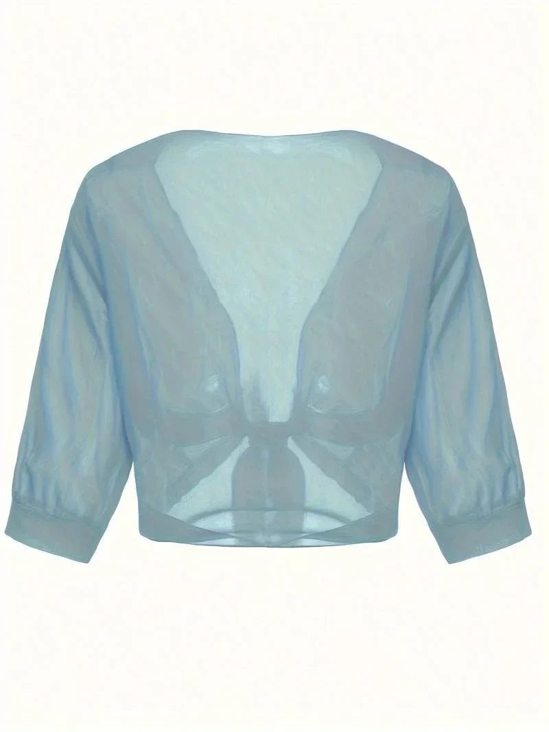 Stylish women's tie-front blouse, sheer fabric, 3/4 sleeves, perfect for layering.