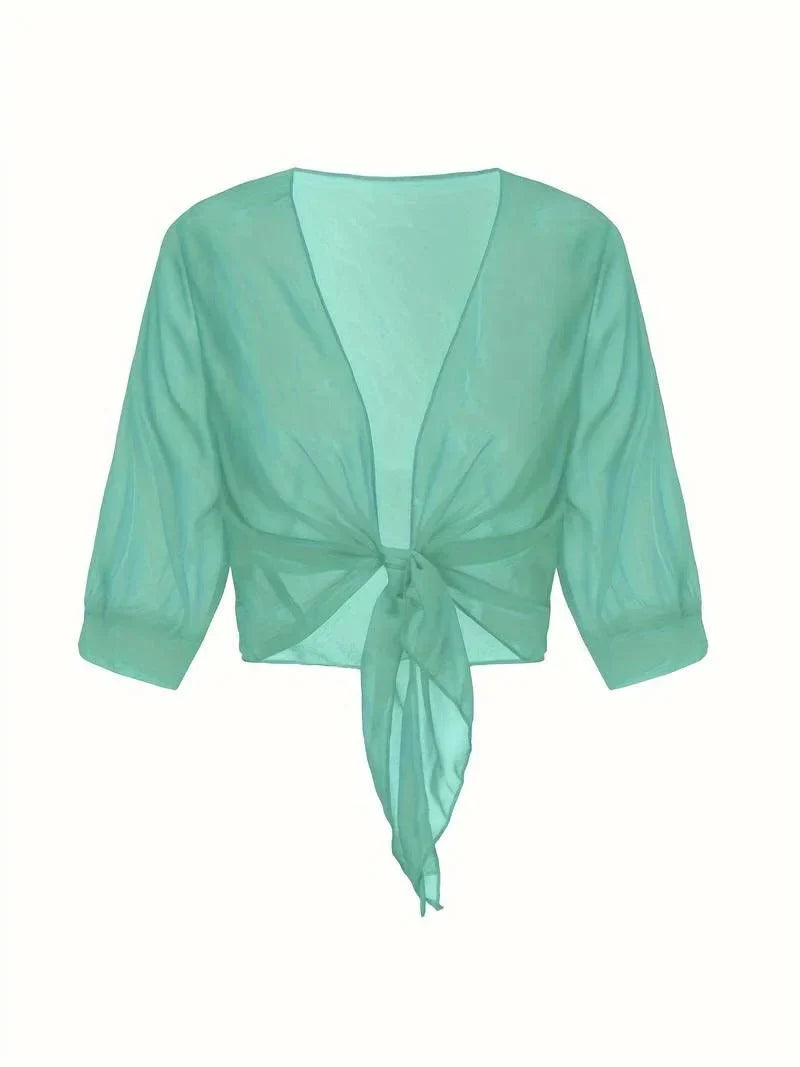 Women's sheer 3/4 sleeve blouse with tie front, elegant and modern design.