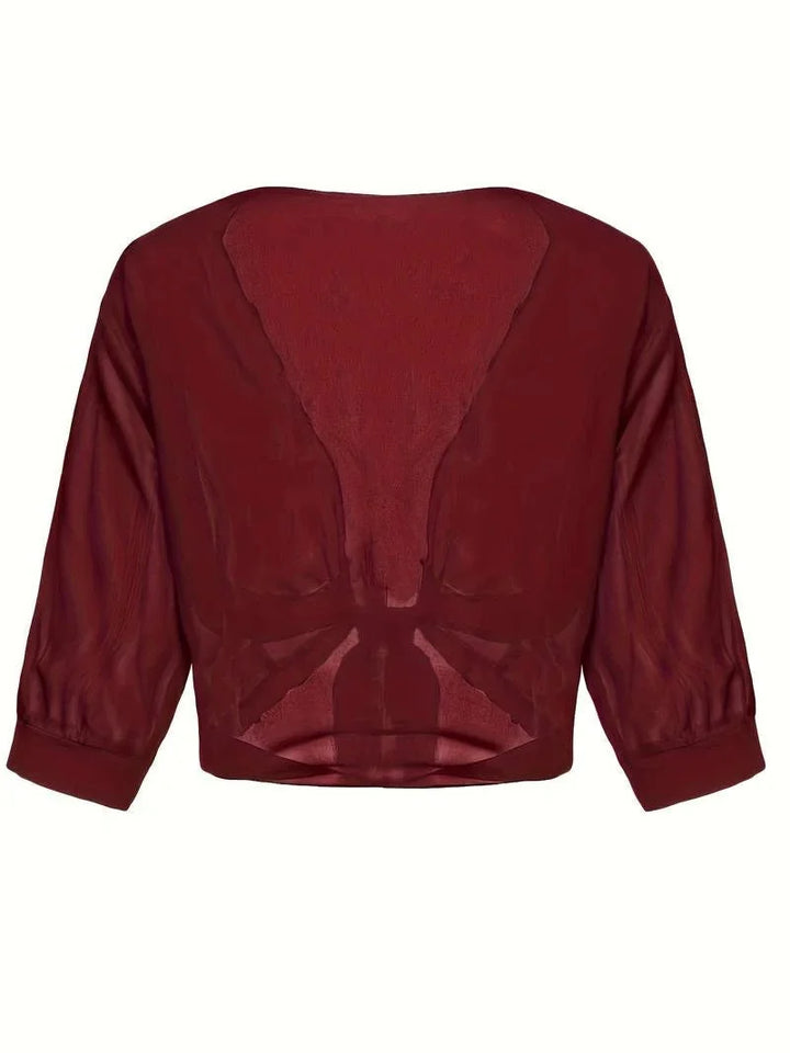 Chic women's sheer top with 3/4 sleeves and a flattering tie-front design.