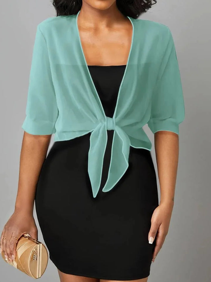 Lightweight women's blouse, sheer fabric, 3/4 sleeve, tie front detail for comfort.